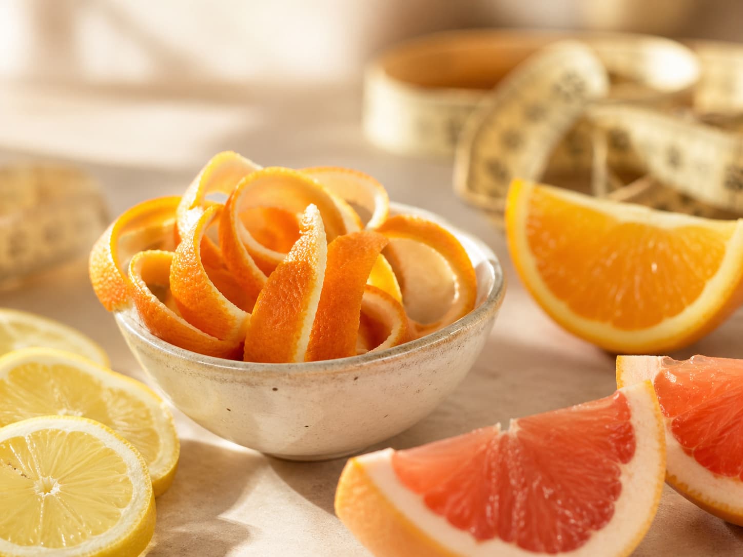 Citrus peels, grapefruit, lemon slices, and a measuring tape representing healthy weight support
